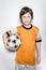 Soccer Player Kid in Orange Uniform With Ball