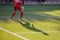 Soccer player shadow on the green artificial football field