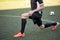 Soccer player stretching leg on field football