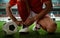 Soccer player tying shoes on the field