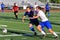 Soccer players chase the loose ball