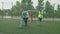 Soccer players jostling for position on football pitch at daybreak