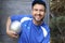 Soccer playing in blue shirt and cap holding silver ball