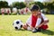 Soccer, sports and girl tie her shoes in training practice for fitness, wellness and youth development. Exercise