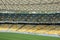 Soccer stadium inside view. football field, empty stands, a crowd of fans, a roof against the sky