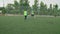 Soccer striker doing tricks, beating defenders, scoring goal outdoors