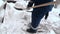 Sochi,Krasnodar Territory,Russia,01.15.2022 Cleaners clean snow piles with a shovel,at the Rosa Khutor ski resort,Krasnaya Polyana