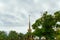 SOCHI,RUSSIA, 18 APRIL 2019 -view of the spire of the building of the sea port through the branches of trees