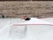 Sochi, Russia - 26 December 2019. The guy performs a trick on a skateboard on the sheer wall of a skatepark