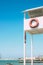 Sochi, Russia - August, 05, 2019. White booth tower with lifebuoy on shore of Black sea