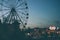 Sochi, Russia - August, 07, 2019. Glowing lights on Ferris wheel, resort nightlife, background, beautiful sky