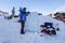 Sochi, Russia - January 24, 2015: Ice carving master making ice sculpture with electric chainsaw on snowy mountain slope of Gorky