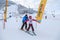 Sochi, Russia - January 9, 2015: Male ski instructor tutors a young beginner girl in skiing on a snowy mountain slope in Gorki