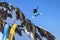 Sochi, Russia - March 25, 2014: Snowboarder flies in air from Big Air jump on blue sky and mountain background