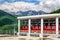 Sochi, Russia - May 23, 2014: Scenic sunny landscape of parked red passenger cabins at RusSki Gorki Ski Jumping Center surrounded