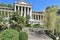 SOCHI, RUSSIA - SEPTEMBER 27, 2020: facade with a porch of the inactive former sanatorium `ORDZHONIKIDZE` surrounded by green vege