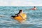 Social distance and virus protection. A woman in a medical mask swims in the sea with an inflatable circle. Side view. In the