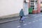 Social distancing lone venerable senior woman shopper in street due to coronavirus UK