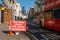 Social Distancing new road layouts sign with a London Double Decker Bus passing and St Paul`s Cathedral in the background during