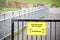 Social distancing sign at school playground road crossing