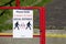 Social distancing sign at school playground road crossing