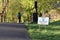 Social distancing sign with solitary runner in background