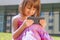 Social Media addiction. Portrait of cute lLittle child girl with smart phone. Psychological problems, media mania, education