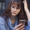 Social Media addiction. young beautiful woman holding a smartphone (psychological problems, media mania)