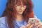 Social Media addiction. young beautiful woman holding a smartphone (psychological problems, media mania)