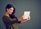 Social media also loves me. Studio shot of an cheerful young woman holding a digital tablet while standing against a