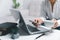 Social media day concept. Female freelancer starting working day early in living room for website with smartphone. Businesswoman