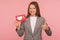 Social media trends, popular content. Cheerful elegant woman in business suit holding network heart Like icon