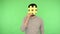 Social network. Positive brunette man in shirt covering face with big yellow hash sign, chroma key
