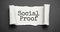 social proof word written under torn paper