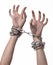 Social theme: hands tied a metal chain on a white background