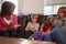 Social Worker Talking To Mother And Children At Home