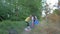 Society against pollution, little girl helps woman to collect plastic and polyethylene refuse in garbage bag while