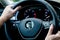 Soest, Germany - August 4, 2019: Close up of hands of driver on steering wheel of Volkswagen car