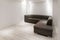 Sofa with chaiselongue in empty renovated apartment