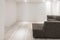 Sofa with chaiselongue in empty renovated apartment