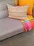 Sofa and cushions in gray and orange tones