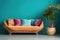 Sofa with multicolored pillows and wicker pot with houseplant against teal wall with copy space