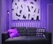 Sofa with pillows on a purple background.