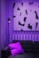 Sofa with pillows on a purple background.