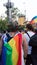 Sofia / Bulgaria - 10 June 2019: Fat guy with Rainbow Flag in the back and Crown of flowers supporting Sofia Pride walking in the