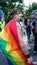 Sofia / Bulgaria - 10 June 2019: Fat guy with Rainbow Flag in the back and Crown of flowers supporting Sofia Pride walking in the