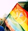 Sofia / Bulgaria - 10 June 2019: Guy holding big Rainbow Flag in the Sofia Pride March walking in the street