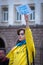 Sofia, Bulgaria - April 28, 2022: A girl holds a poster to support Ukraine