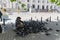 SOFIA, BULGARIA - MAY 3 2019: The bird lady in Sofia, Bulgaria sitting at her usual place in the town in front of the courthouse