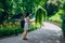 Sofia Park, Uman. Young woman with a backpack walking in the park. Girl in a sundress and a tourist map on the trail in the park.